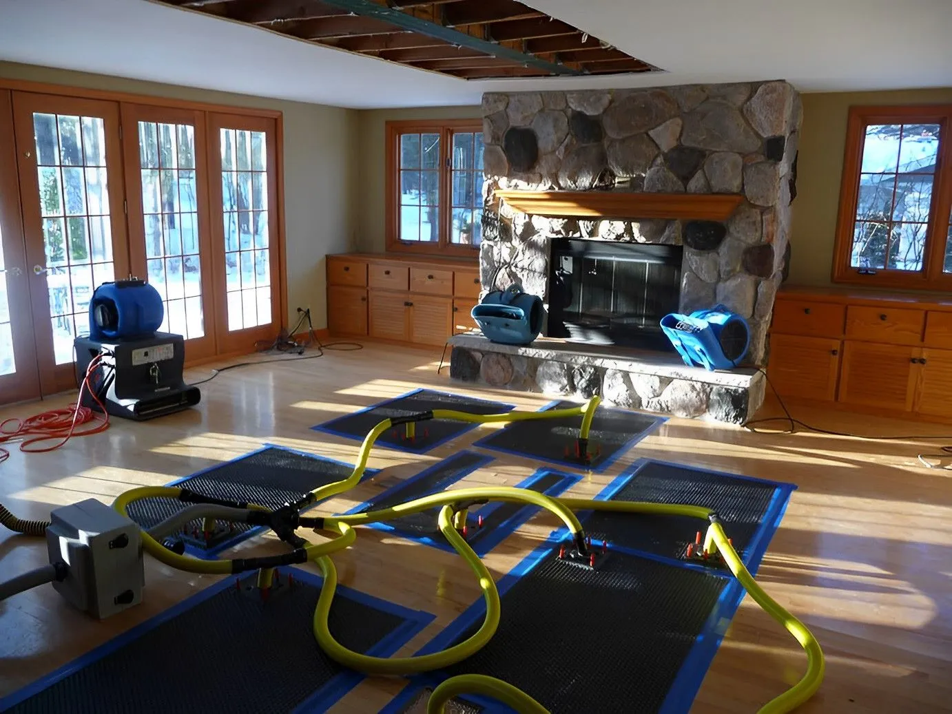Wet hardwood floor drying after water damage in a Toronto home